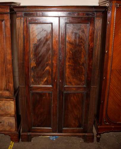 A 19th Century mahogany hanging wardrobe, enclosed by a pair...