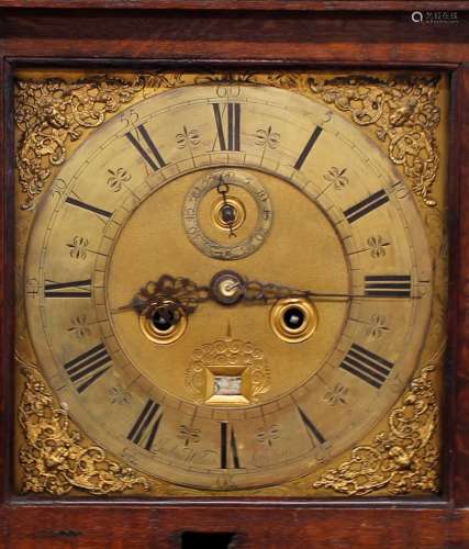 An 18th Century oak cased long cased clock, the hood surmoun...