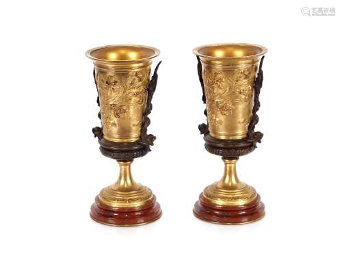 A pair of Classical style bronze urns, with foliate and beas...