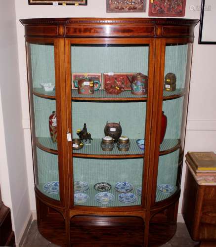 An Edwardian inlaid mahogany bow fronted display cabinet, th...
