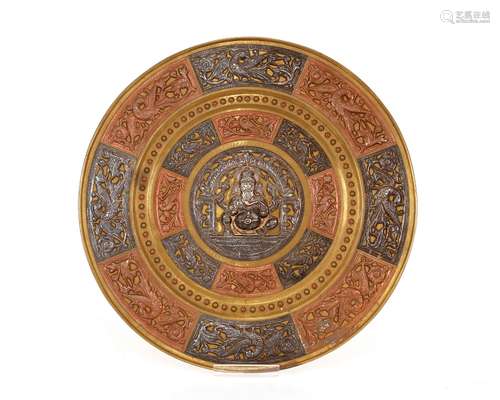 An Indian brass, copper and white metal circular plaque, wit...