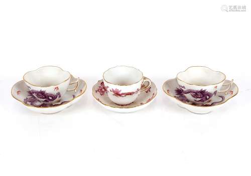 A pair of Meissen cups and saucers, decorated dragons and fl...