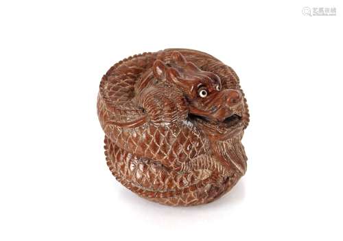 A Japanese wooden figure of a coiled dragon