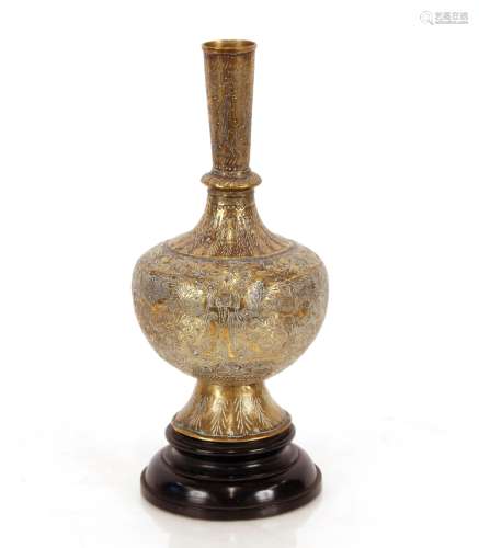 An Indian brass bottle shaped vase, an later hardwood stand,...