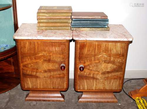 A pair of French Art Deco walnut bedside cabinets, surmounte...