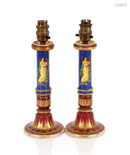 A pair of 19th Century porcelain candlesticks, decorated in ...