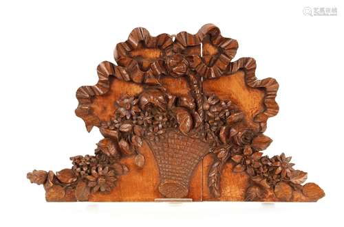 A 19th Century carved panel, of shaped form decorated with t...