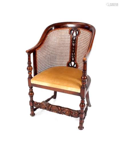 An oak tub shaped Bergere chair, raised on turned baluster f...