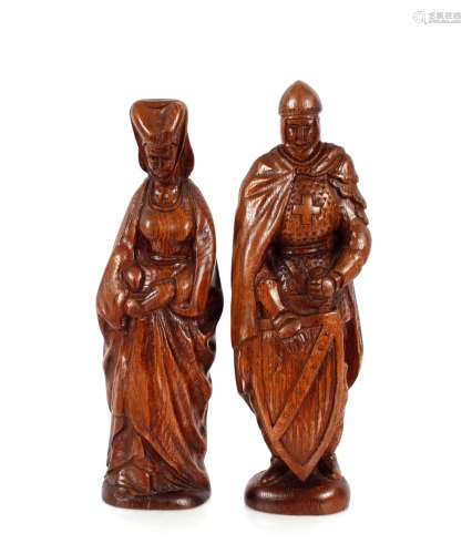 A pair of carved oak figures, of a Medieval knight and lady,...