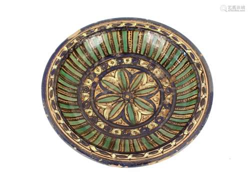 A North African glazed pottery shallow dish, having multi co...