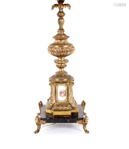 An ornate gilt metal table lamp, decorated with porcelain pl...