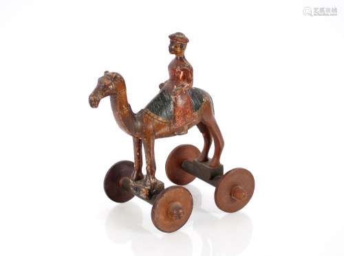 A 19th Century pull along toy, in the form of a camel and ri...