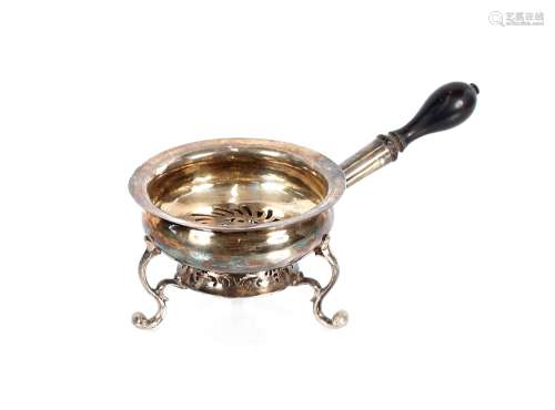 An early George III silver hot dish, with turned ebony handl...