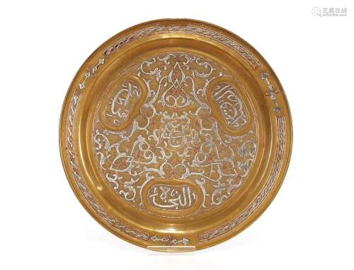 An Eastern brass and white metal inlaid tray, 33cm dia.