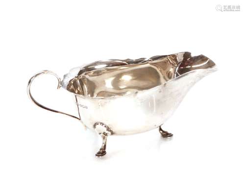 A silver sauce boat, Sheffield 1937, with serrated border an...