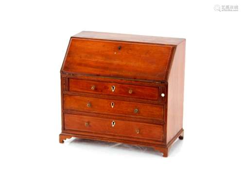 A miniature mahogany bureau, the fall front revealing a fitt...