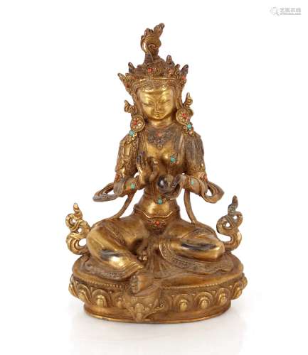 A gilt bronzed Tibetan Buddha, inlaid with turquoise and cor...