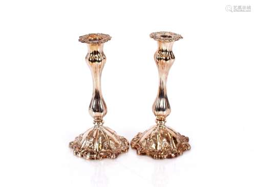 A pair of plate on copper Rococo style candlesticks, with fo...