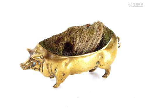 A Victorian brass pen wipe, in the form of a pig,11cm long