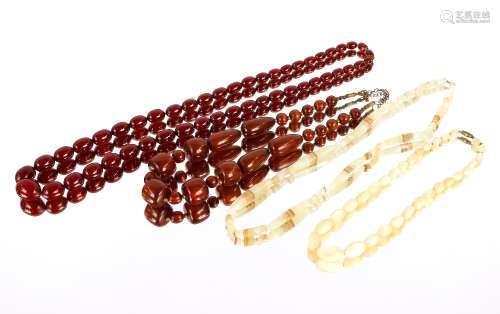 A cherry amber coloured string of graduated beads; another s...