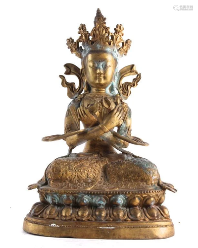 A GILT BRONZE FIGURE OF A TIBETAN BUDDHA