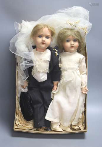 A pair of Armand Marseille 390 bisque head groom and bride d...