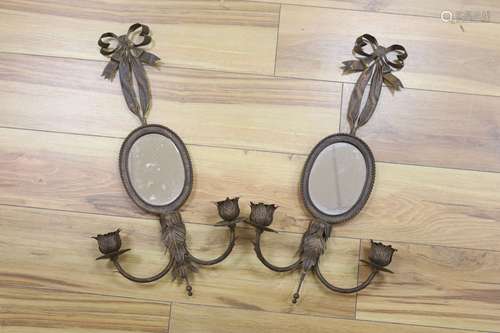 A pair of wrought copper oval two branch girandole mirrors, ...