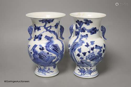 A pair of Chinese blue and white 'phoenix' vases, Kangxi mar...