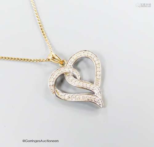 A modern 375 and diamond chip set openwork heart pendant, 22...