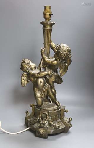 A gilt metal cherubic table lamp, signed, overall height 50c...