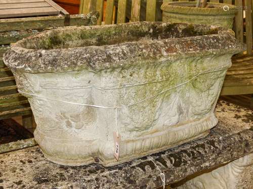 A pair of reconstituted stone shaped oval planters with swag...