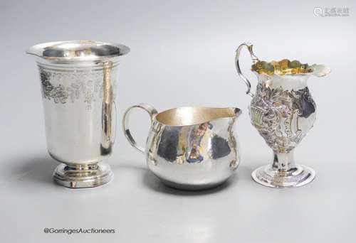 A George III later embossed silver cream jug with later base...