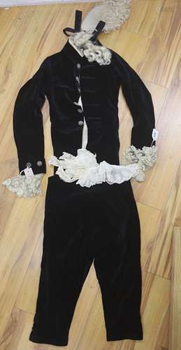 A 19th century black velvet page boys outfit with wig and la...