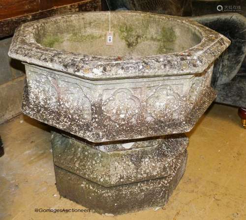 A large weathered Victorian octagonal carved stone font, wid...