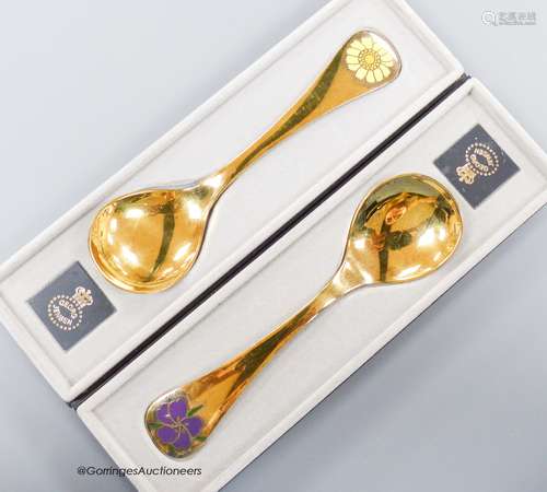 Two boxed Georg Jensen gilt sterling and enamel year spoons,...