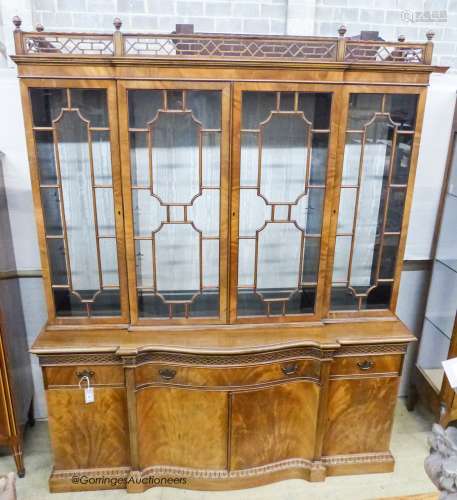 A Georgian style mahogany serpentine front library bookcase,...