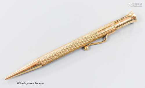 A late 1940's engine turned 9ct gold cased pencil, with engr...