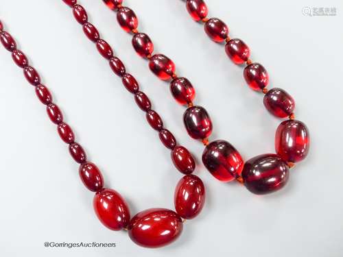 Two single strand graduated simulated cherry amber oval bead...