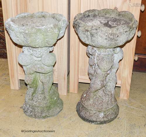 A pair of reconstituted stone circular tulip form planters o...