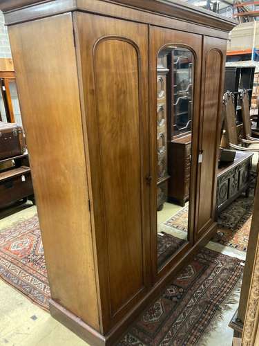 A Victorian mahogany triple mirrored wardrobe, bears Heals &...