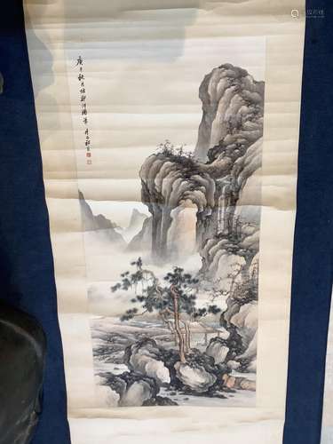 A Chinese scroll painting of a scholar seated in a mountaino...