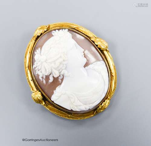 A late Victorian yellow metal mounted oval cameo shell brooc...