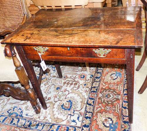 A George III rectangular oak side table fitted frieze drawer...