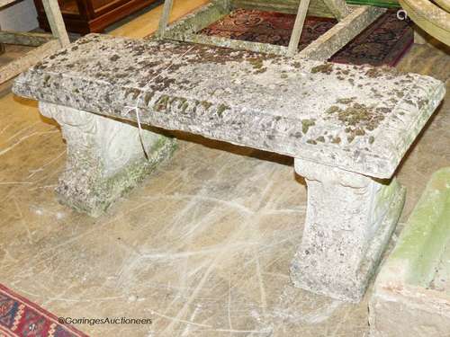 A reconstituted stone bench having moulded rectangular top o...