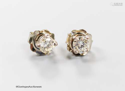 A modern pair of 750 white metal and solitaire diamond ear s...