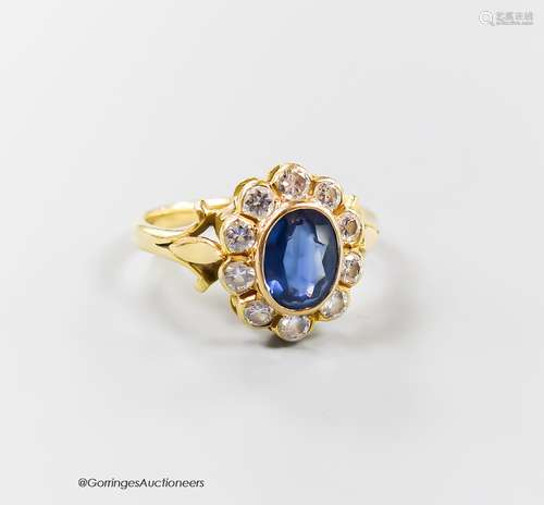 A modern 18ct gold, sapphire and diamond set oval cluster ri...