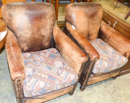 A pair of tan leather upholstered armchairs, width 70cm, dep...