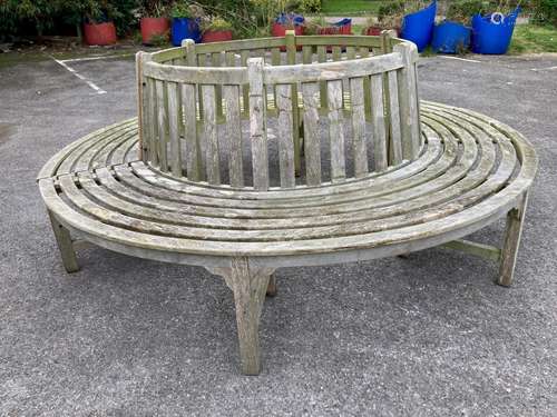 A weathered teak two section garden tree seat, diameter appr...