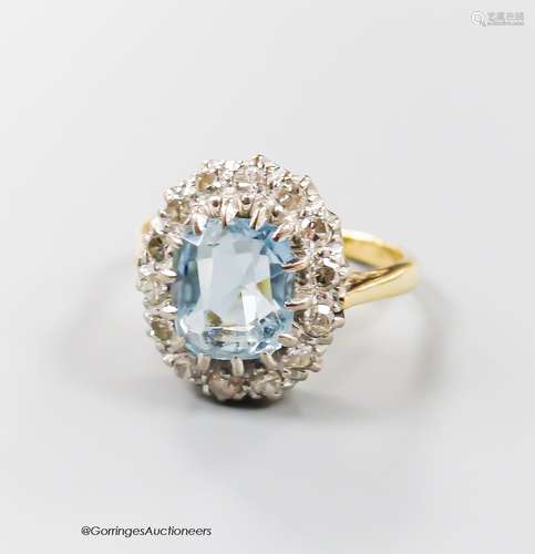 An 18ct, aquamarine and diamond set oval cluster ring, size ...