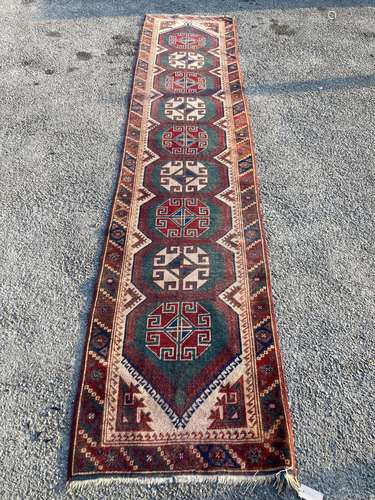 A Caucasian design green ground runner, 340 x 76cm